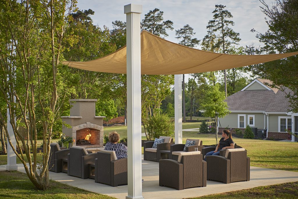 A new patio with outdoor fireplace was added between the new pocket neighborhoods and existing community spaces.