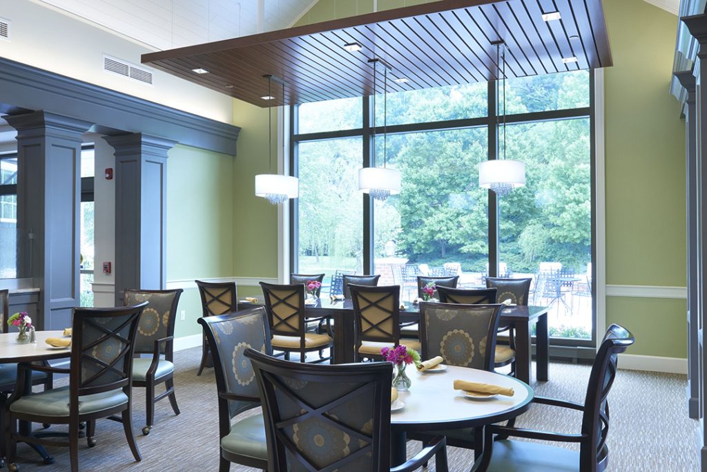 The appealing colonial elements were maintained, but updated with a fresh and natural color scheme that reflects the vibrancy of the adjacent patio and the campus landscaping visible through the large storefront-style windows.