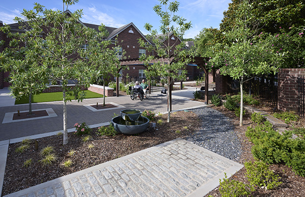 The new therapy courtyard provides an outdoor opportunity for residents to practice walking on various surfaces.